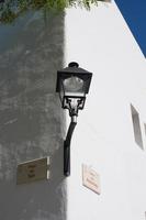 Lamp on the corner of a building photo