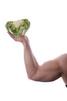 Raw food man holding vegetables and fruit photo