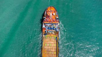 Aerial view on top of cargo ship carrying container and running for export cargo yard port to international custom ocean. Concept of technology transportation , customs clearance, webinar banner. photo