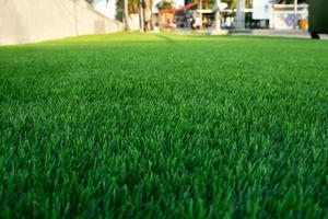 Green artificial grass in the park, natural background texture, Wallpaper and background. photo