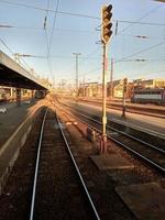 A train traveling down train tracks near a station photo