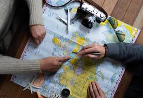 Friend planning for vacation trip with accessories of traveler photo