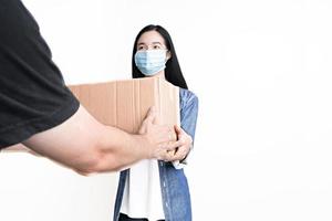 Women wear health mask receive parcel from delivery man photo