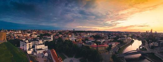 Aerial view old castle tower in Old Town and Vilnius city panorama background, capital city of Lithuania. Scenic landmarks and sightseeing in eastern europe. Travel Lithuania concept. photo