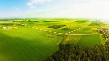 Aerial fly over scenic scenic agricultural farming fields in countryside Lithuania.