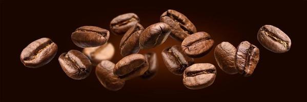 Falling coffee beans isolated on black background photo