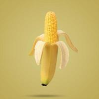 Cob of corn in the peel of banana on yellow background. Fruit concept. Food creative concept. Photo manipulation with banana. Art concept.