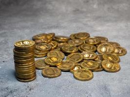 Pyramid of coins on a gray background. A pile of coins. photo