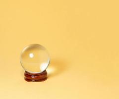 Crystal ball on a yellow background. photo