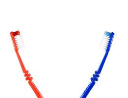 Two toothbrushes on a white background. Blue and red toothbrushes photo