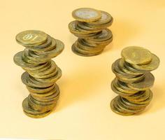 Coin turrets. Money on yellow background photo