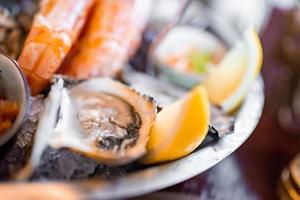 Fresh oysters on a plate with other seafood. photo