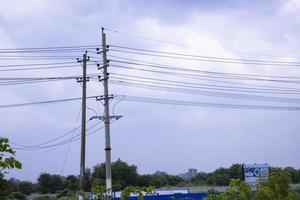 High voltage Electricity pylon under the cloudy blue sky photo