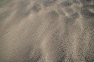 sand texture. wavy sand textured background. sand textured beach photo