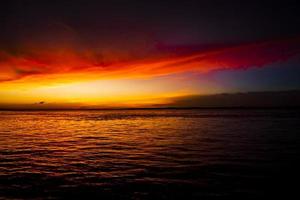 Beautiful  Scenic View Of Sea Against Orange Sky photo