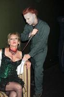 LOS ANGELES, OCT 30 - Donna Keegan and Michael Myers Costumed Guest at the sCare Foundation Halloween Launch Benefit at Conga Room, LA Live on October 30, 2011 in Los Angeles, CA photo