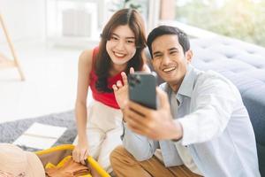 Young adult southeast asian couple selfie together for upload internet social media before travel photo