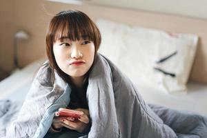 Portrait of young asian teenager woman in bedroom. photo