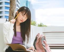 retrato de la hermosa cara de un estudiante del sudeste asiático al aire libre foto