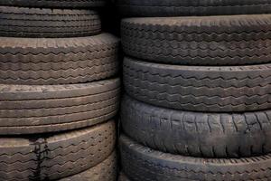Pile of tires and wheels for rubber. Closeup for design work photo