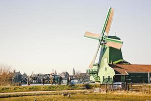 old Dutch mills in motion located in the city of Amsterdam photo