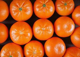 Fresh mandarin oranges in a black box photo