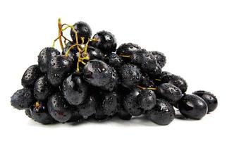 A bunch of black grapes is isolated on a white background. Water drops on grapes. photo