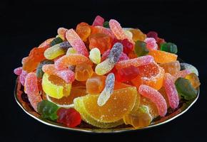 A full plate of colorful marmalade candy. a top view. Marmalade background. photo