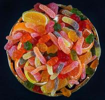 A full plate of colorful marmalade candy. a top view. Marmalade background. photo