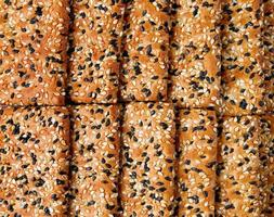 Laid in two rows of cookies sprinkled with black and white sesame. photo