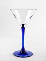 The martini glass is isolated on a white background. photo