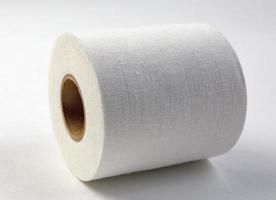 Medical sticking plaster roll on white. First aid item photo