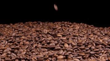 grains de café torréfiés tombant en tournant au ralenti. video