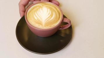 Barista presenting latte art to customer, close up cafe latte, coffee shop barista lifestyle video