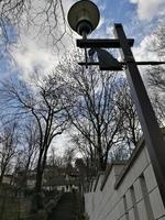 A street lamp hanging off the side of a building in Miskolc photo