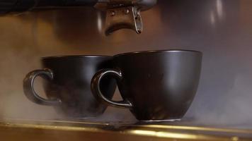 caffè espresso versando dalla macchina per caffè espresso. fare il caffè fresco uscendo da una macchinetta del caffè. avvicinamento. scatto professionale con risoluzione 4k. video