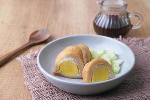 Pempek, Empek-Empek, traditional food from South Sumatra, Indonesia. This fish-based food is very popular. Served with cuko sauce and cucumber slices. photo