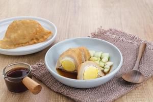 Pempek, Empek-Empek, traditional food from South Sumatra, Indonesia. This fish-based food is very popular. Served with cuko sauce and cucumber slices. photo