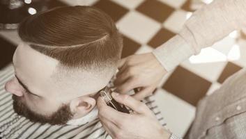 Male hipster in barbershop photo