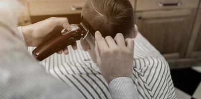 Man getting haircut by barber photo