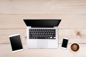 Top view laptop computer or notebook,mobile phone and cup of coffee on wooden table. Business template mock up for adding your text. photo