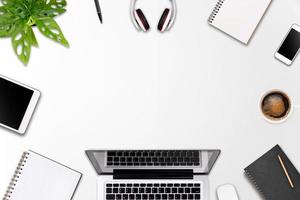 Modern workspace with laptop tablet, smartphone and coffee cup copy space on color background. Top view. Flat lay style. photo