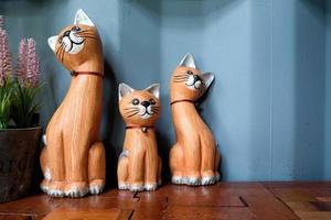 Three cat doll on wood table photo