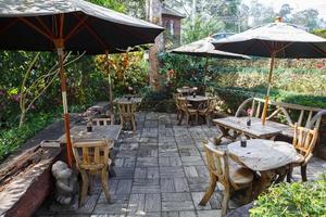 wooden dining table set in garden photo