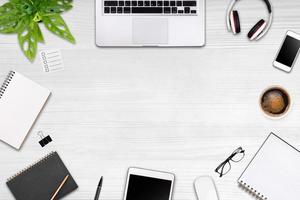 Modern workspace with laptop tablet, smartphone and coffee cup copy space on color background. Top view. Flat lay style. photo