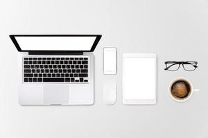 Laptop tablet smartphone eyeglass and coffee on white background with text space and copy space photo