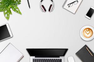 Modern workspace with laptop tablet, smartphone and coffee cup copy space on color background. Top view. Flat lay style. photo