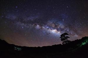 Milky Way Galaxy and Silhouette of Tree with cloud.Long exposure photograph.With grain photo