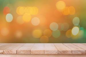 brown wood table top on bokeh abstract orange background - can be used for montage or display your products photo