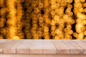 brown wood table top on bokeh abstract orange background - can be used for montage or display your products photo